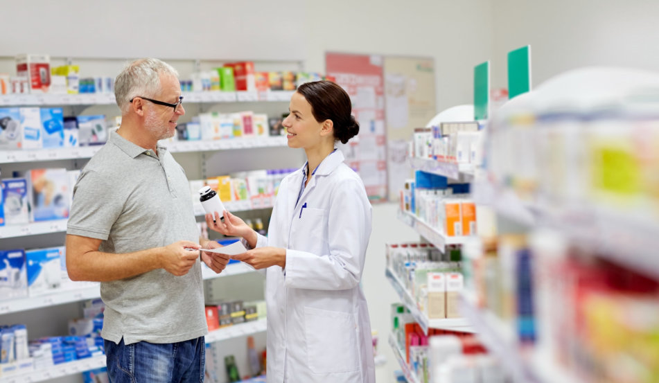 happy pharmacist giving drug to senior man customer and taking prescription at drugstore