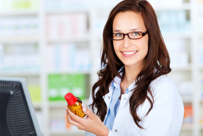  portrait of a cheerful female pharmacist checking the medication